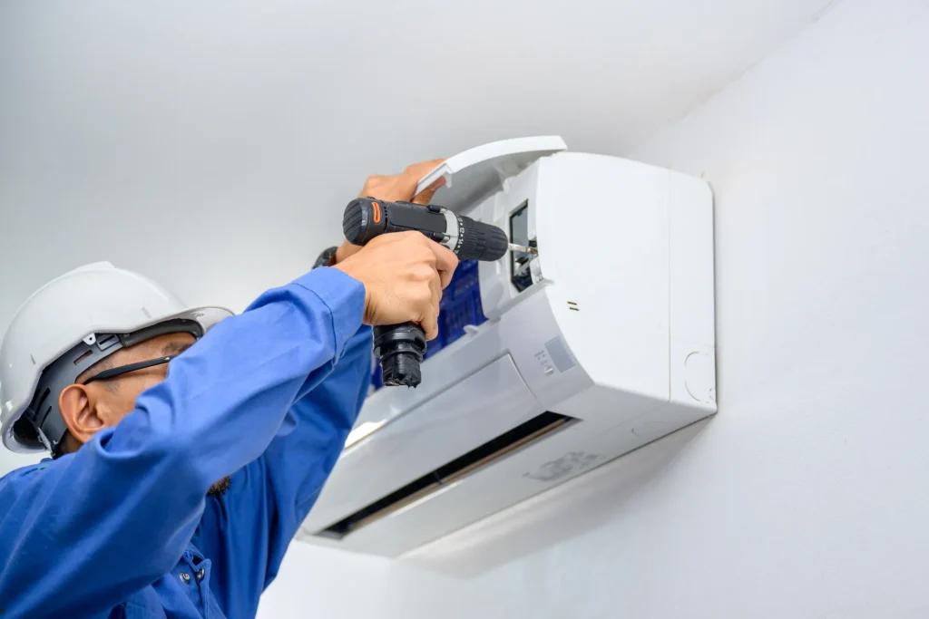 Technician installing Air Conditioning Unit